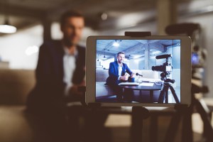 Vlogger on digital tablet screen
