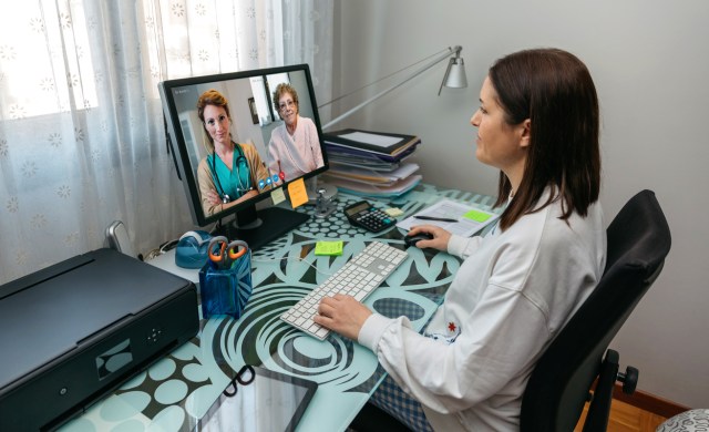 Woman talking on video call with her mother and doctor giving medical report