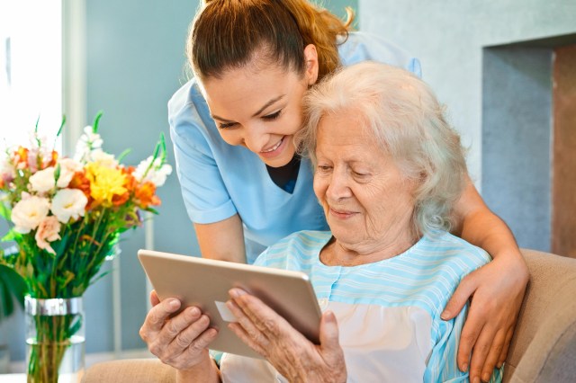 Epicor-Nurse-Looking-Senior-Woman-Digital-Tablet-0520