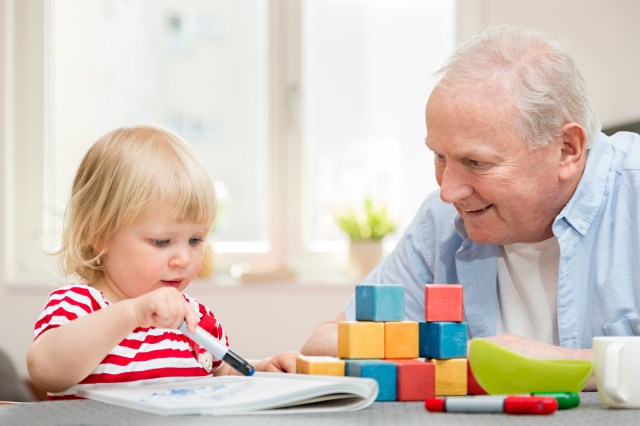 Happy grandfather and granddaughter together at home