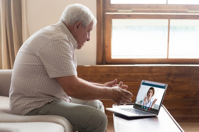 Elderly man have video call with doctor at home