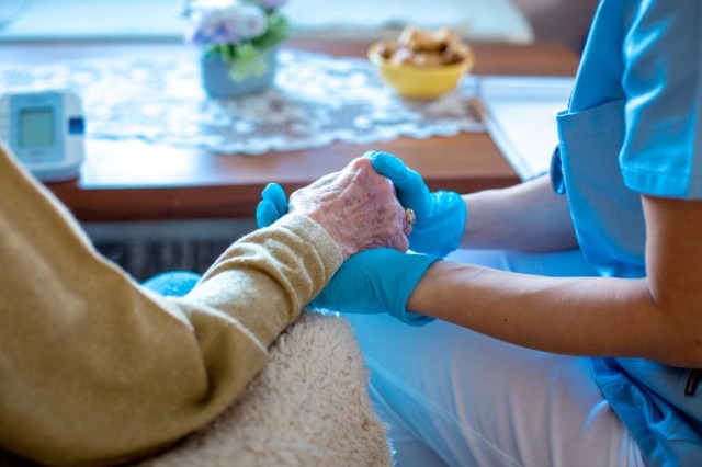 comforting-hands-closeup-surgical-gloves-picture-id1295849229