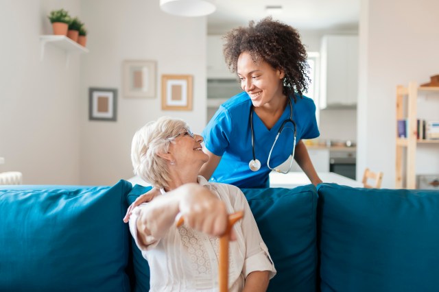 Portrait of Smiling Senior Woman and Her Mixed Race Female Caregiver