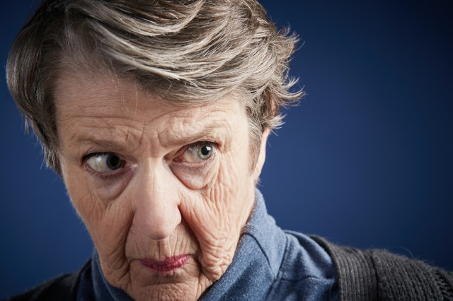 Senior woman looks to the side fearfully