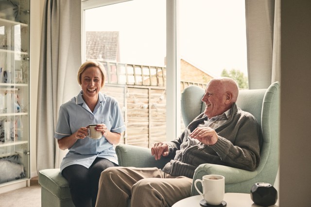 older man and female nurse care worker home care