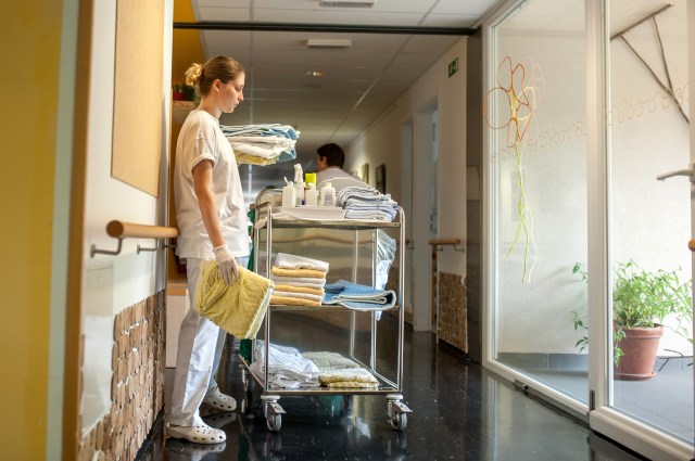 Nurse Changing Laundry In The Nursing Home