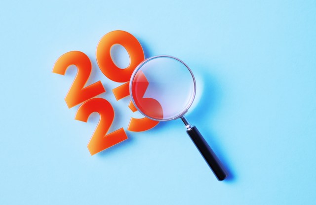 Magnifier And 2023 On Blue Background
