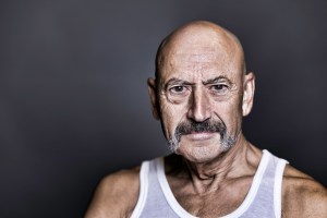 Gay senior man wearing a white singlet