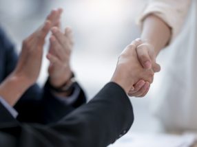 Business people handshake for teamwork of business merger and acquisition, two businessman shake hand with partner to celebration business deal.
