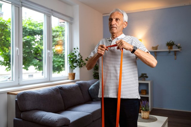 Senior man exercising at home