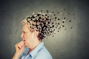 Senior woman losing parts of head feeling confused as symbol of decreased mind function.