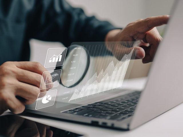 The analyses of large amounts of data and the idea of business intelligence. Charts of the company finances are displayed on a screen that is simulated.