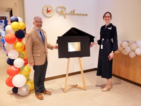 Rev Dr Graham Vawser and Jess Margrate unveil the plaque hero