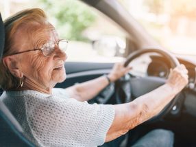 Elderly woman behind the steering wheel