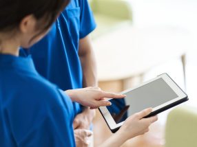 Caregiver viewing materials on tablet