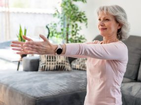Active Senior Woman Stretching At Home