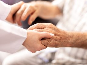 Cropped shot of a female nurse hold her senior patient's hand. Giving Support.